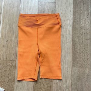 Year of Ours Bandier biker shorts in orange with rib detail